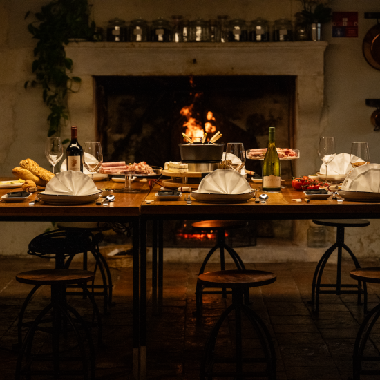 Fire side in charming Le Logis with a table full of delicious food and wine